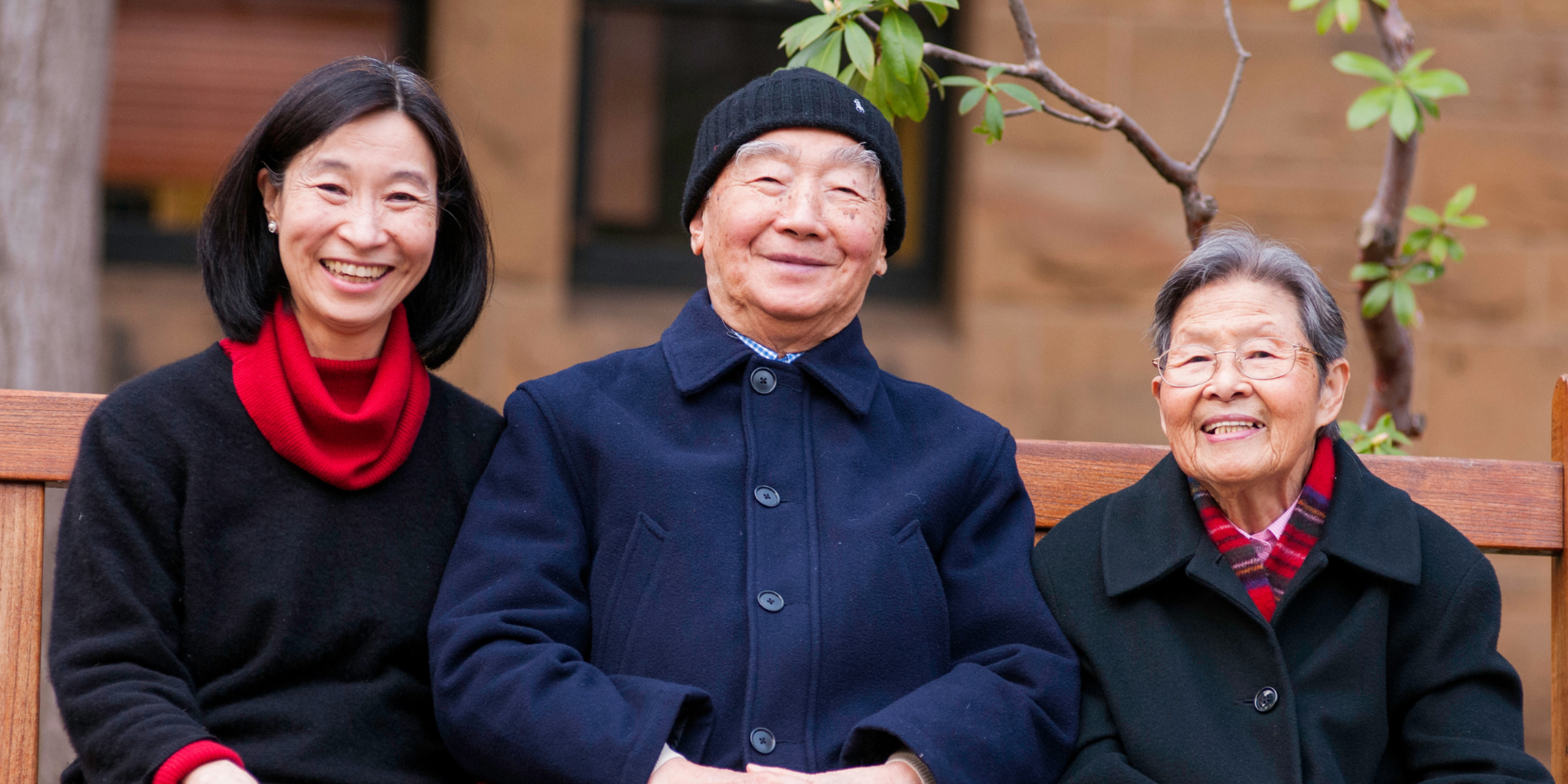 Adela Chau sitting with her parents