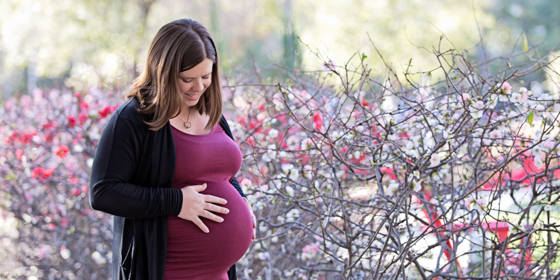 Pregnant Stanford employee looking at her baby bump