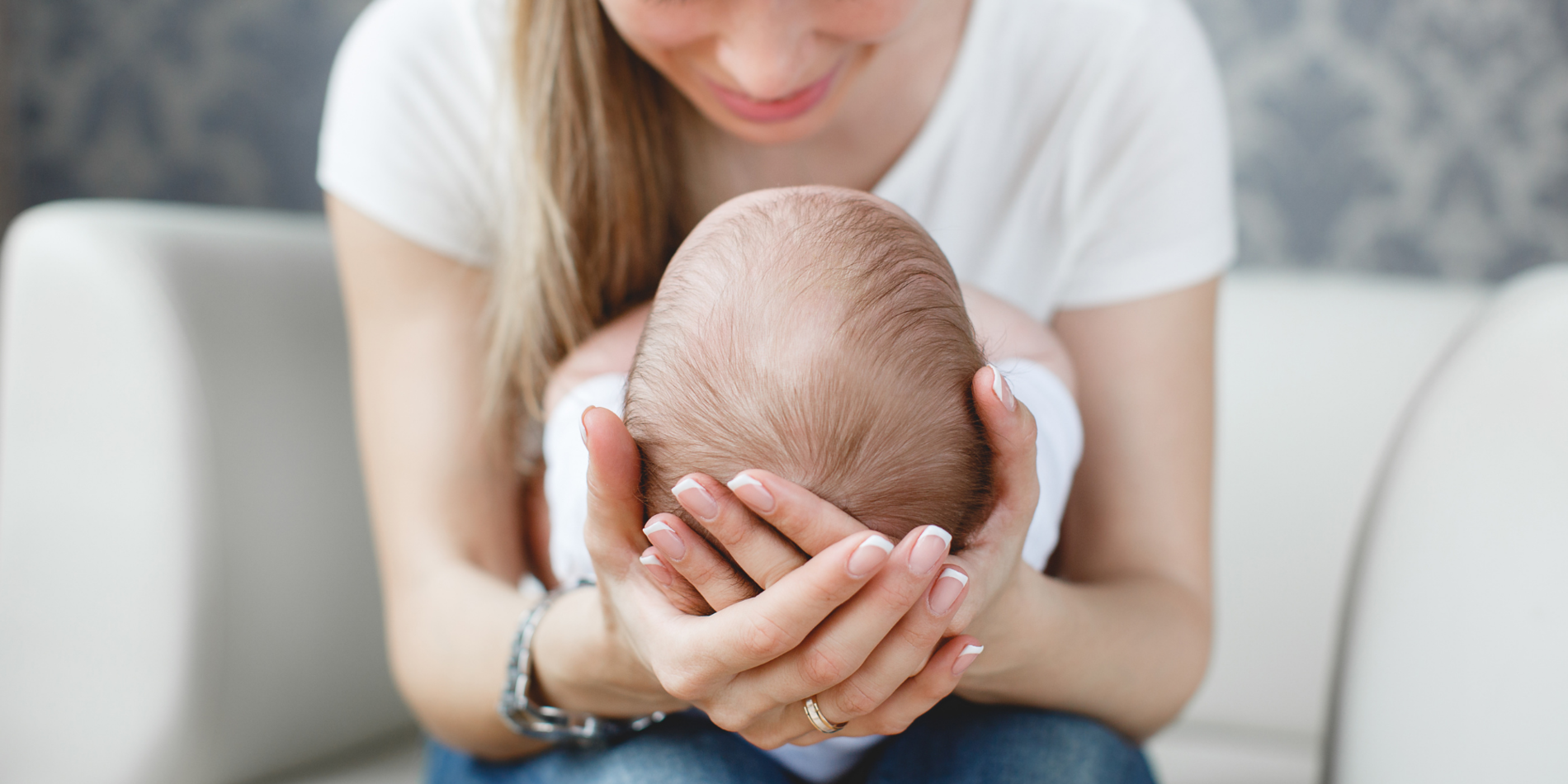 Newborn baby sleeping in mother's arms