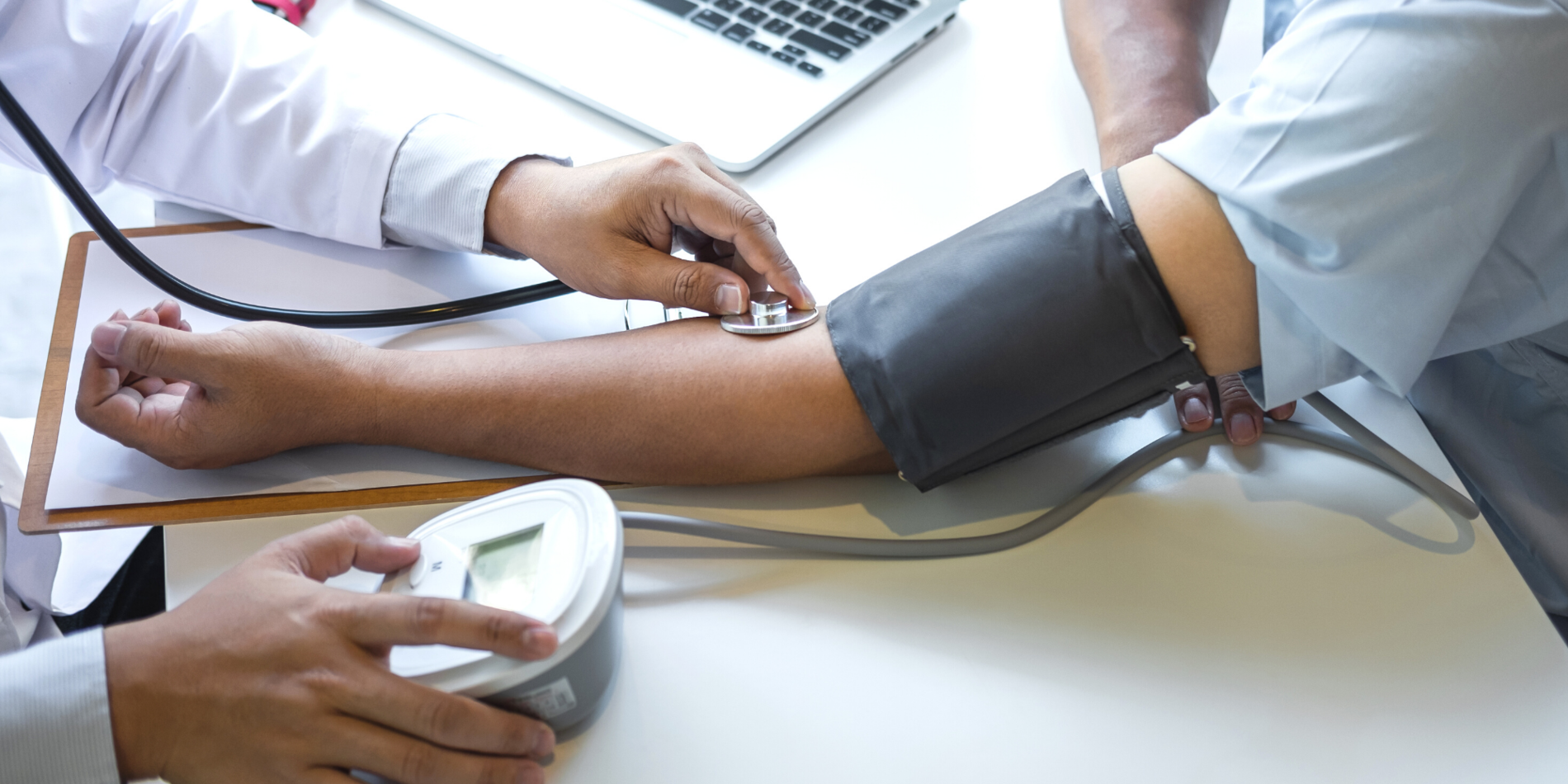 Doctor taking patient's blood pressure