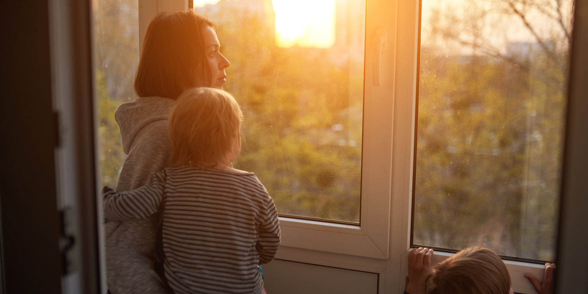 Woman with two sons looking out the window