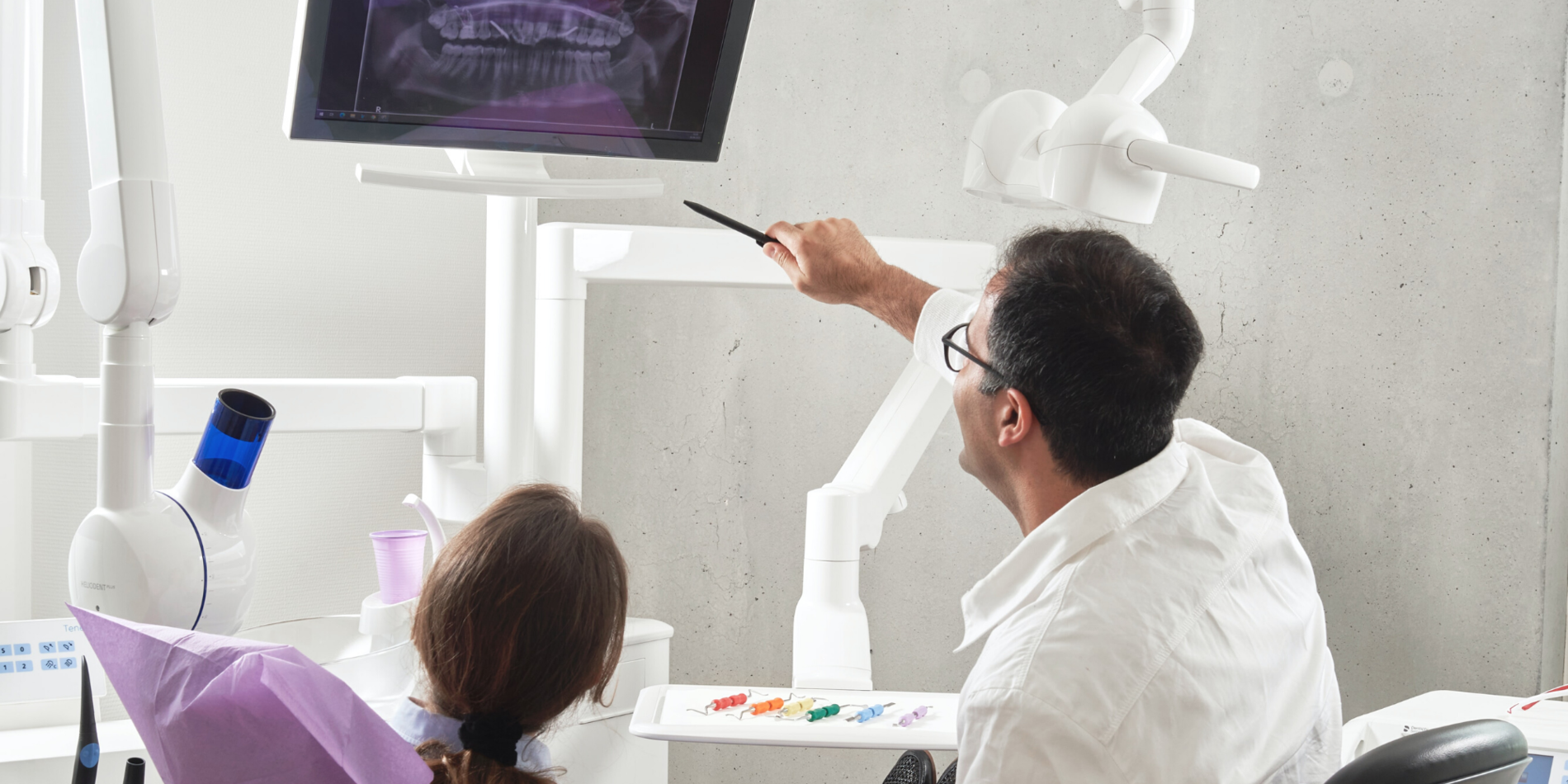 Dentist showing patient xray