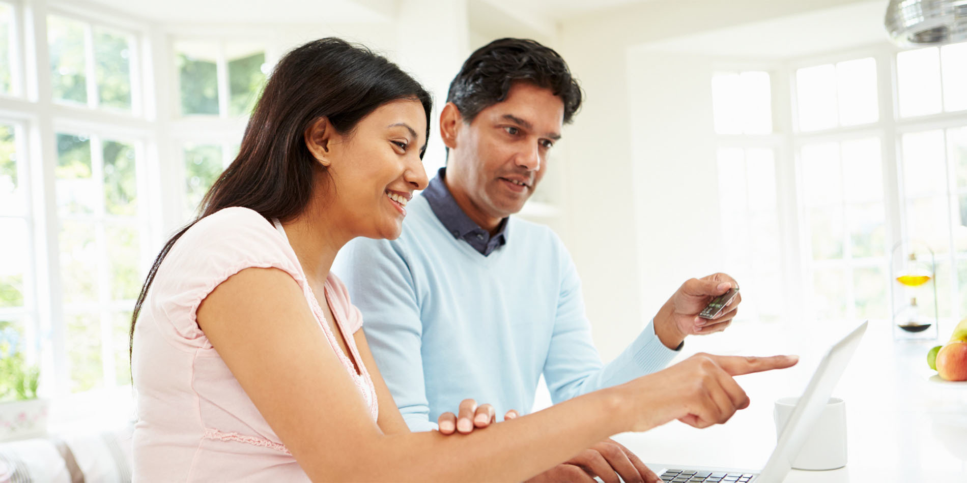 Indian couple making an online purchase at home