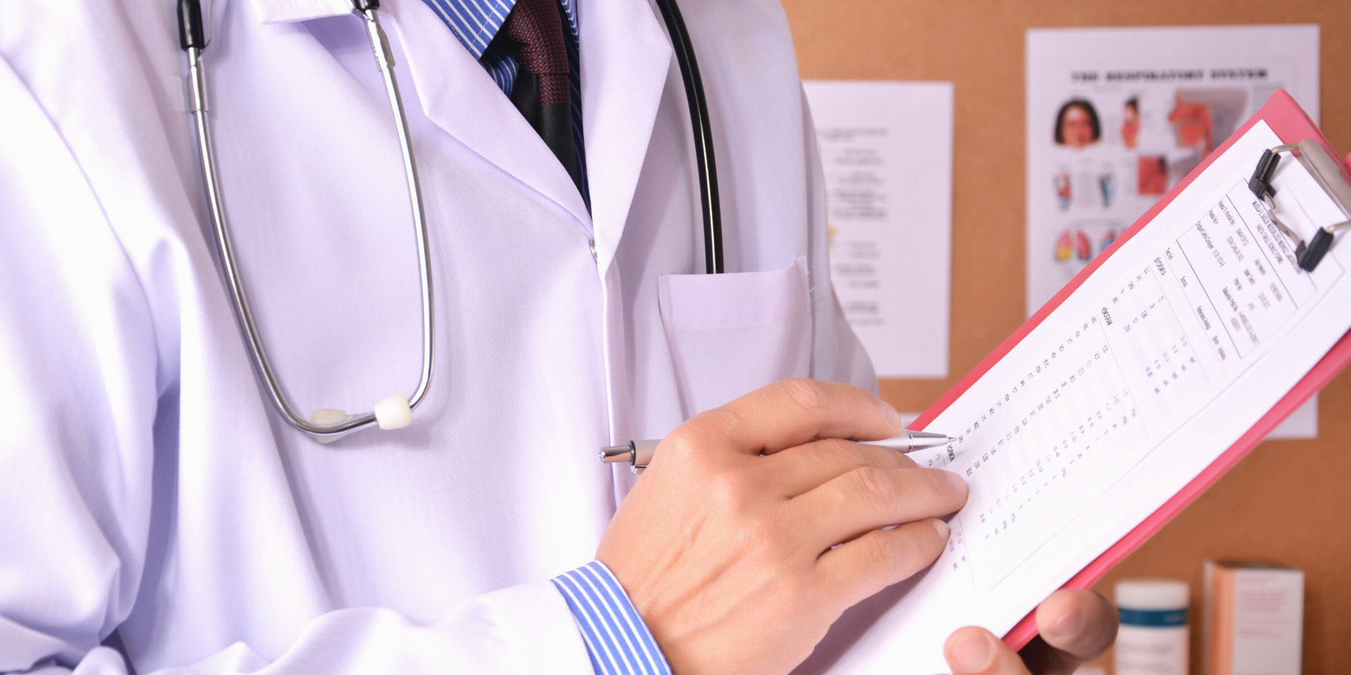 Doctor taking notes on a clipboard