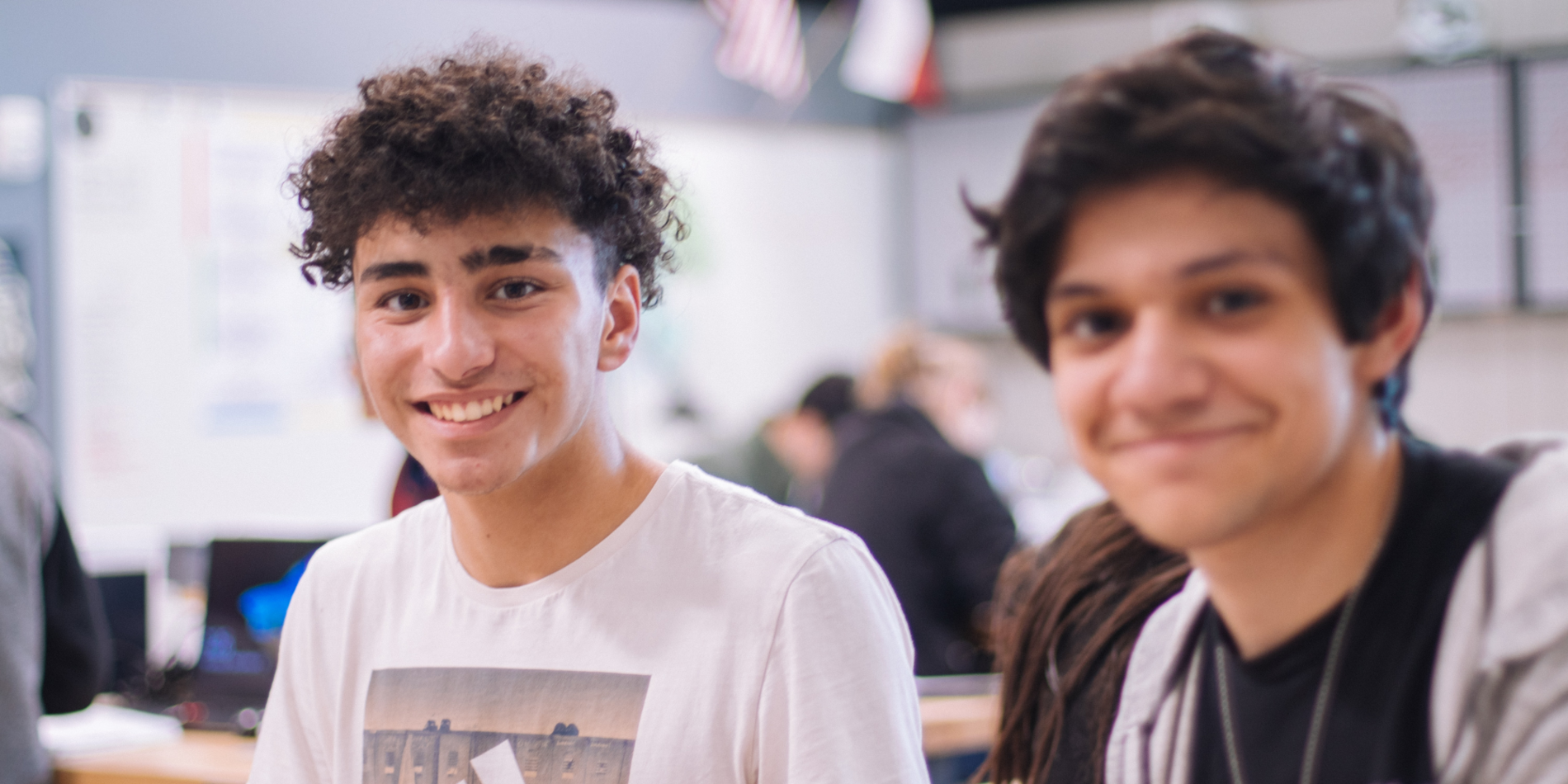 Two teen male students smiling for the camera