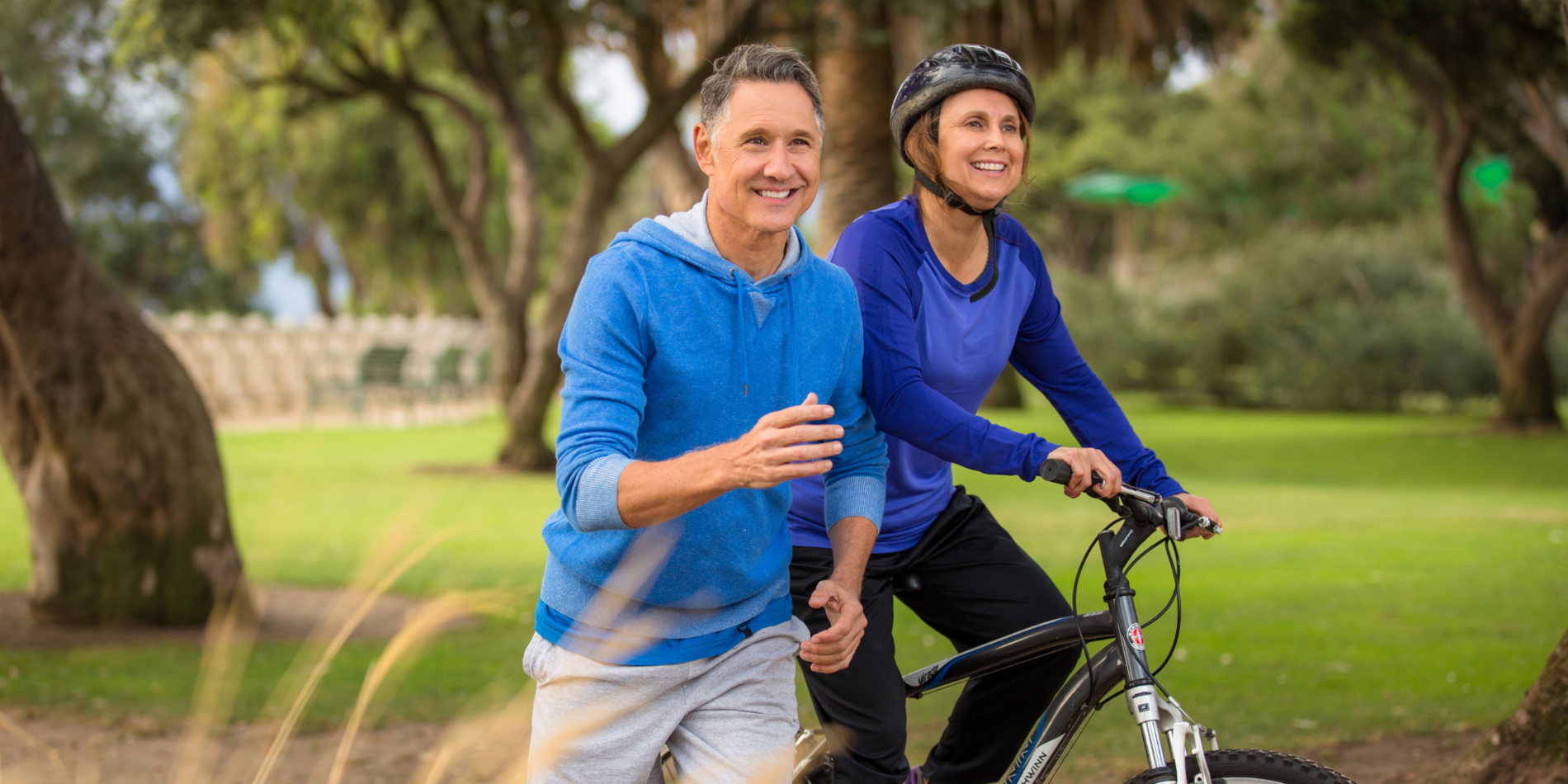 mature couple exercising together in a park