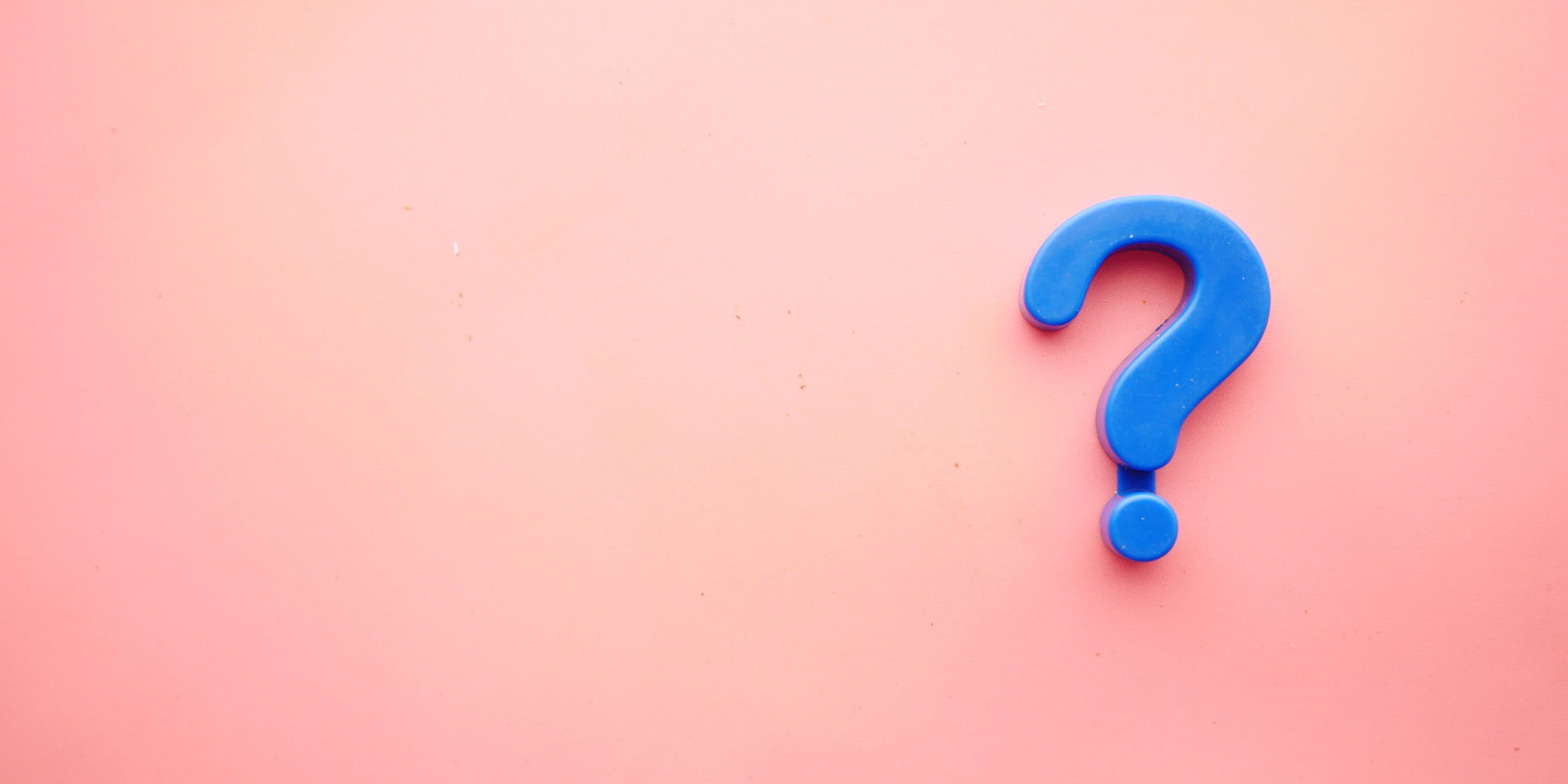 Blue question mark against pink background