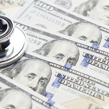 Stethoscope on a stack of money